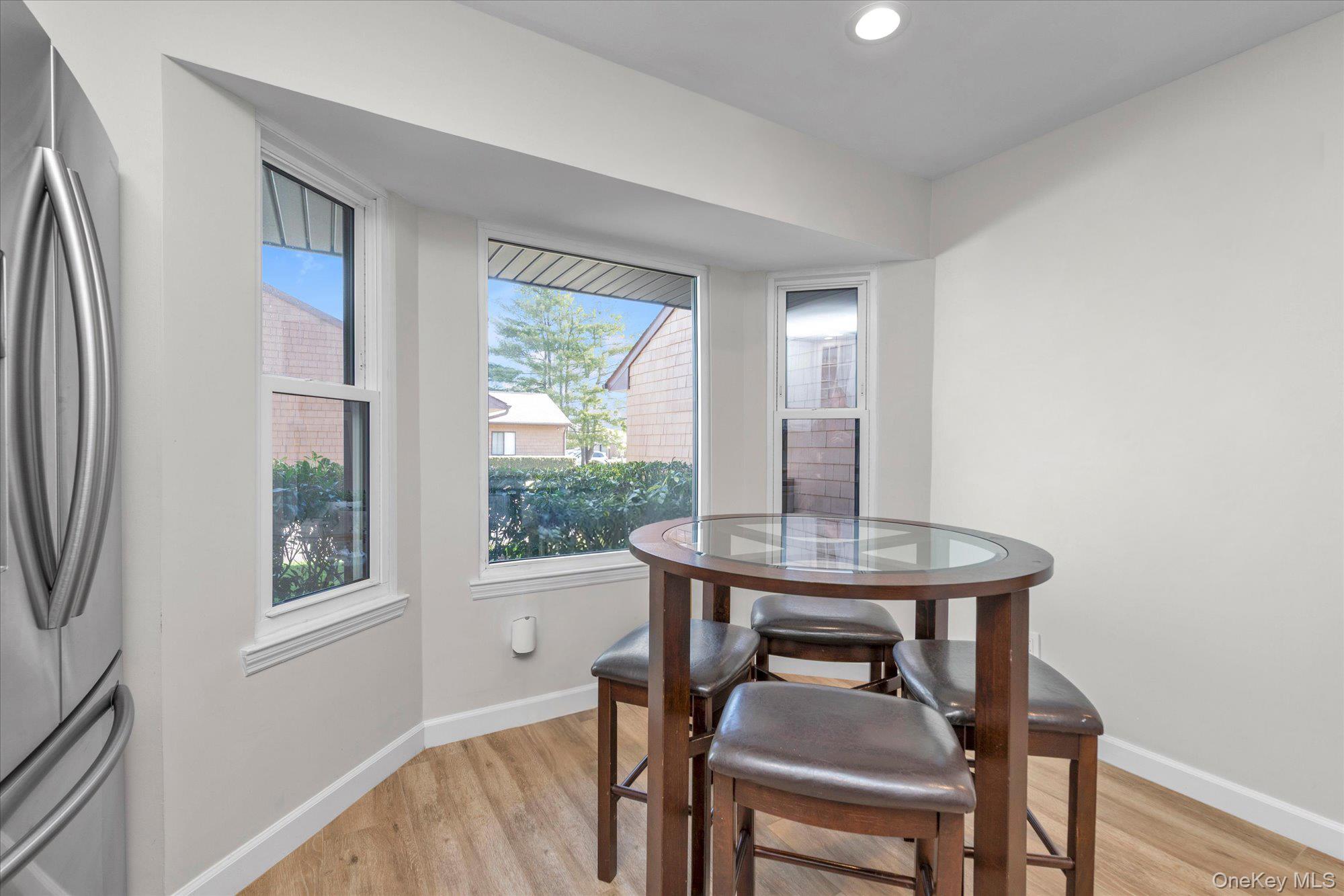 32 Ashley Circle Commack, NY 11725 - Photo 9 of 23 a view of a dining room with furniture window and wooden floor
