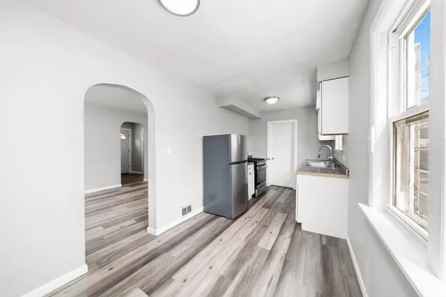 a view of a room with wooden floor and windows