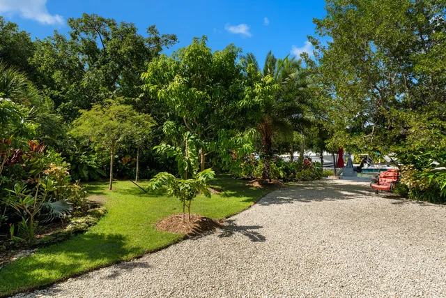 an aerial view of a house with garden space and street view