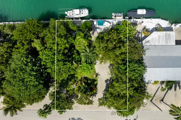 a view of a house with a yard and lake view