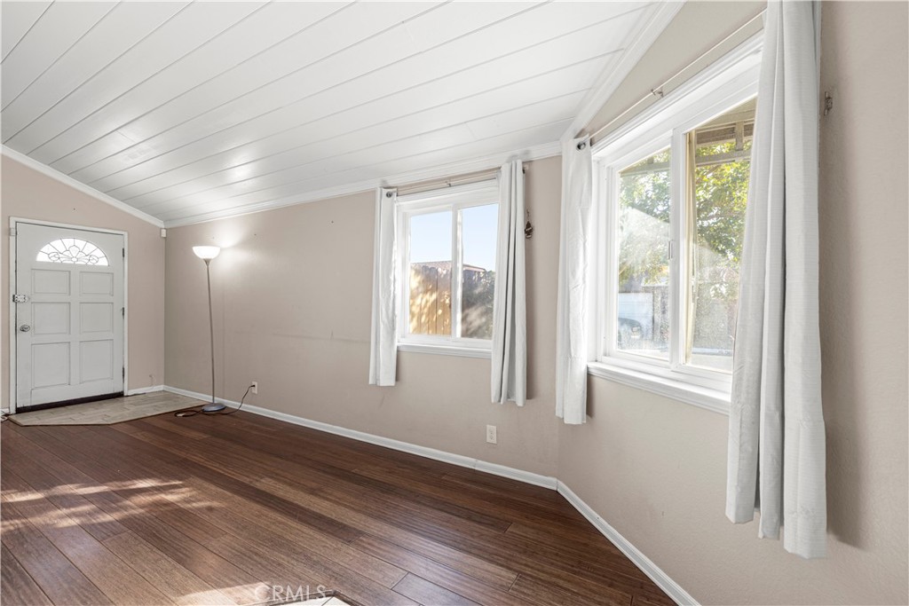 881 South Lamarr Street Rialto, CA 92376 - Photo 11 of 54 a view of an empty room with wooden floor and a window