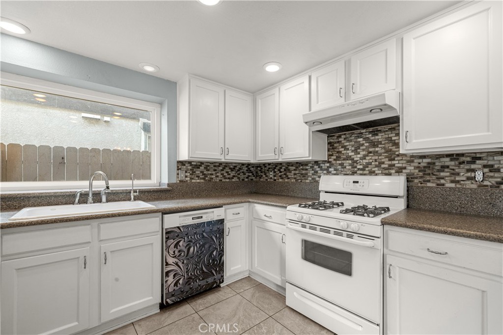 881 South Lamarr Street Rialto, CA 92376 - Photo 15 of 54 a kitchen with white cabinets sink and appliances