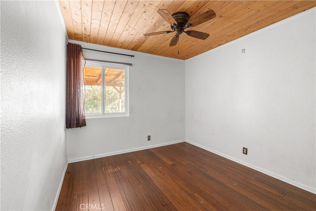 881 South Lamarr Street Rialto, CA 92376 - Photo 32 of 54 an empty room with a window and a ceiling fan