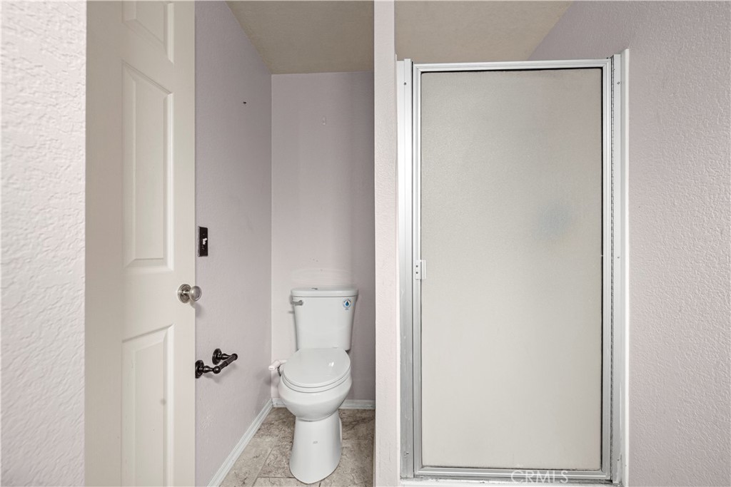 881 South Lamarr Street Rialto, CA 92376 - Photo 36 of 54 a white toilet sitting next to a bathroom sink