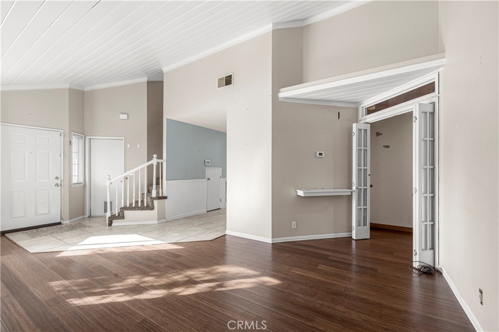 881 South Lamarr Street Rialto, CA 92376 - Photo 9 of 54 a view of a hallway with wooden floor and staircase