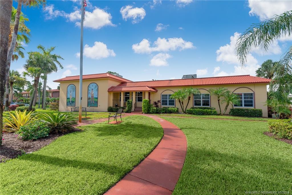 1999 Southwest Palm City Road, Unit G Stuart, FL 34994 - Photo 11 of 23 a front view of house with yard and outdoor seating