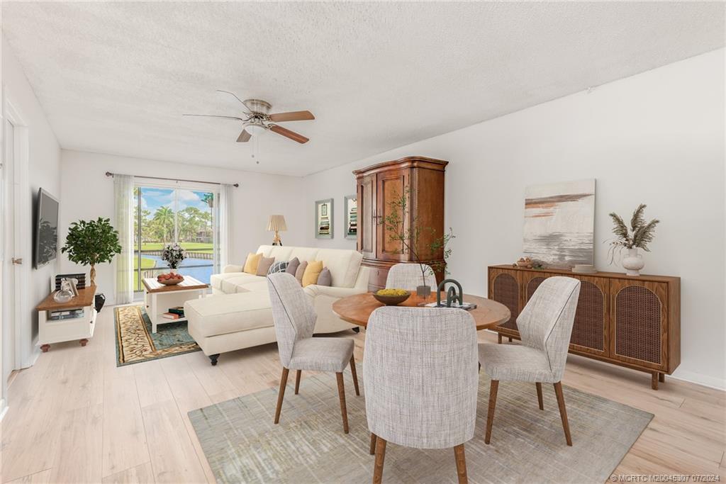 1999 Southwest Palm City Road, Unit G Stuart, FL 34994 - Photo 3 of 23 a living room with furniture or couch and a large window