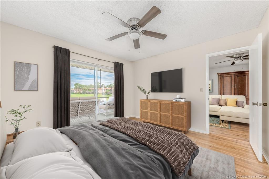 1999 Southwest Palm City Road, Unit G Stuart, FL 34994 - Photo 4 of 23 a bedroom with a bed and a flat screen tv