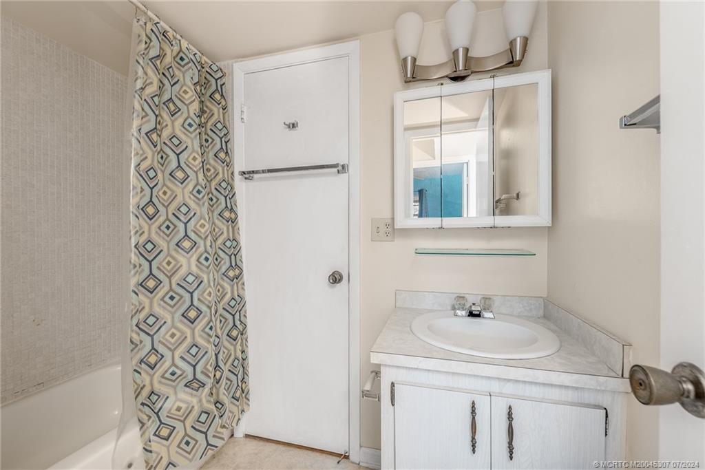 1999 Southwest Palm City Road, Unit G Stuart, FL 34994 - Photo 7 of 23 a bathroom with a sink a vanity and a shower