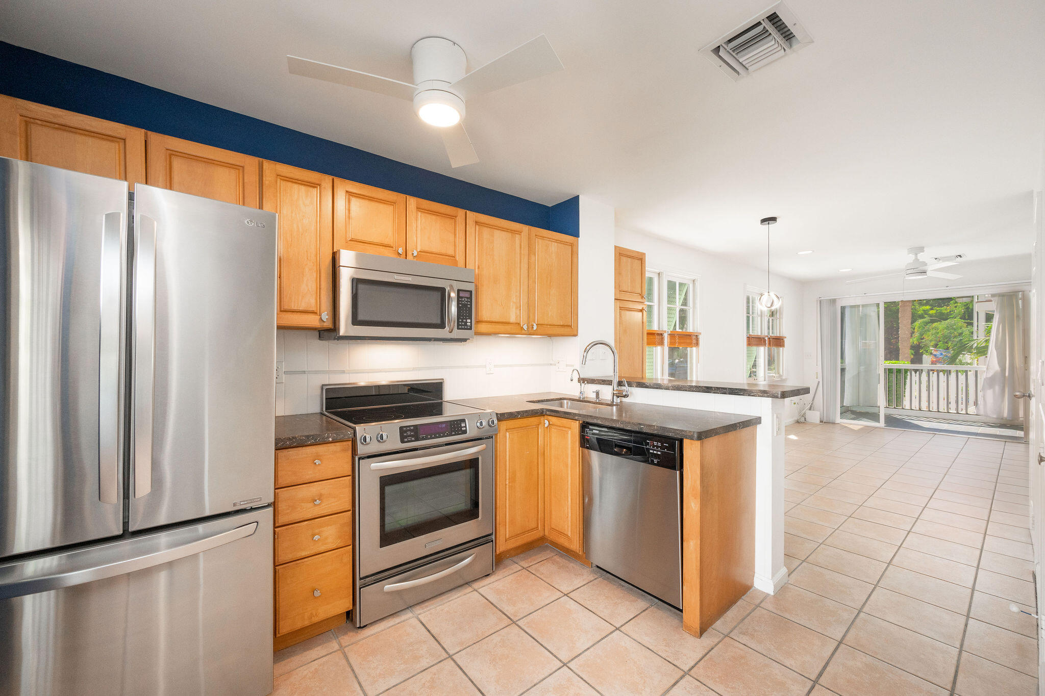 1 Spoonbill Way Key West, FL 33040 - Photo 14 of 38 a kitchen with stainless steel appliances granite countertop a stove top oven a sink and a refrigerator