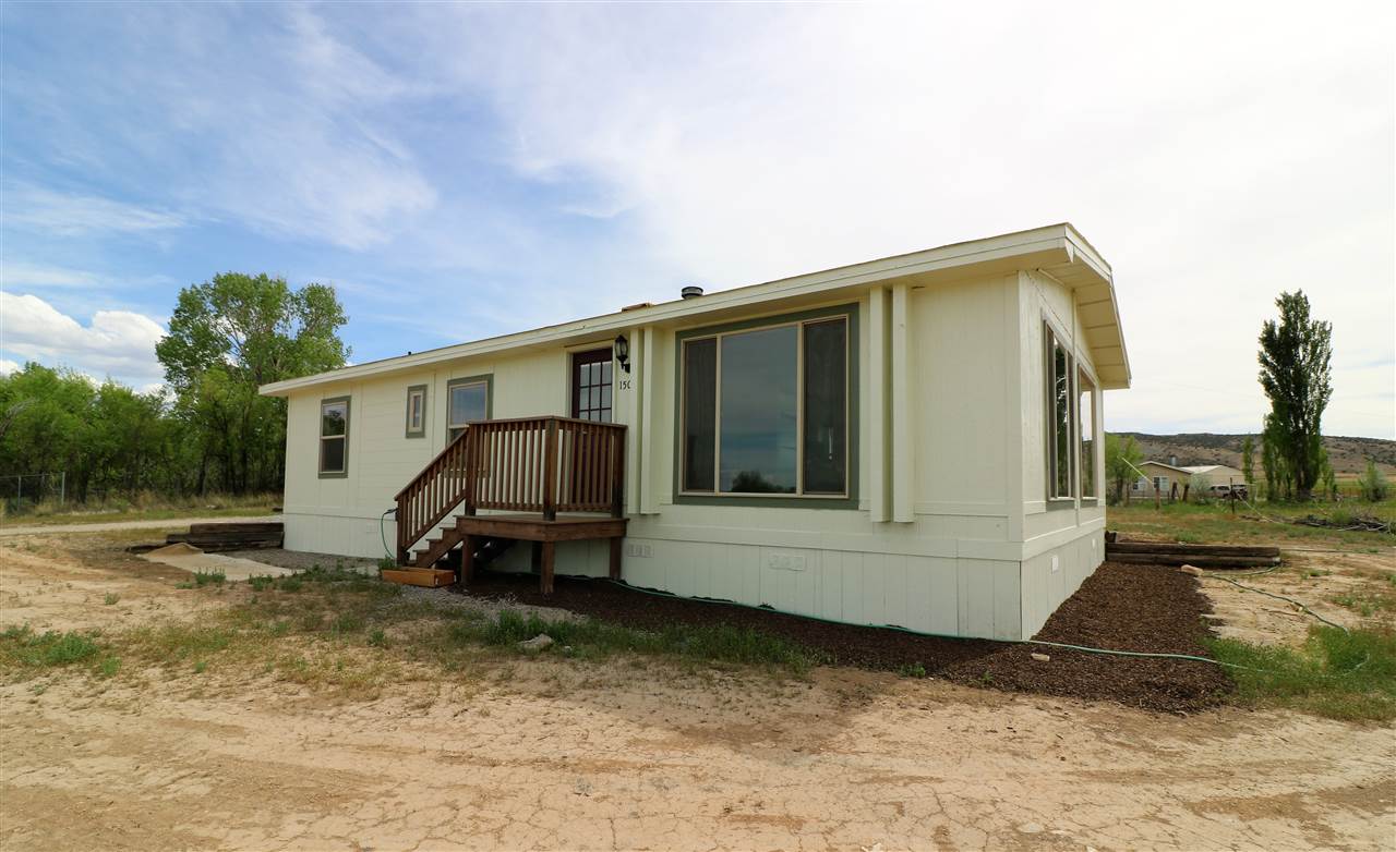 1505 10 Road Mack, CO 81525 - Photo 1 of 27 a view of a house with a yard