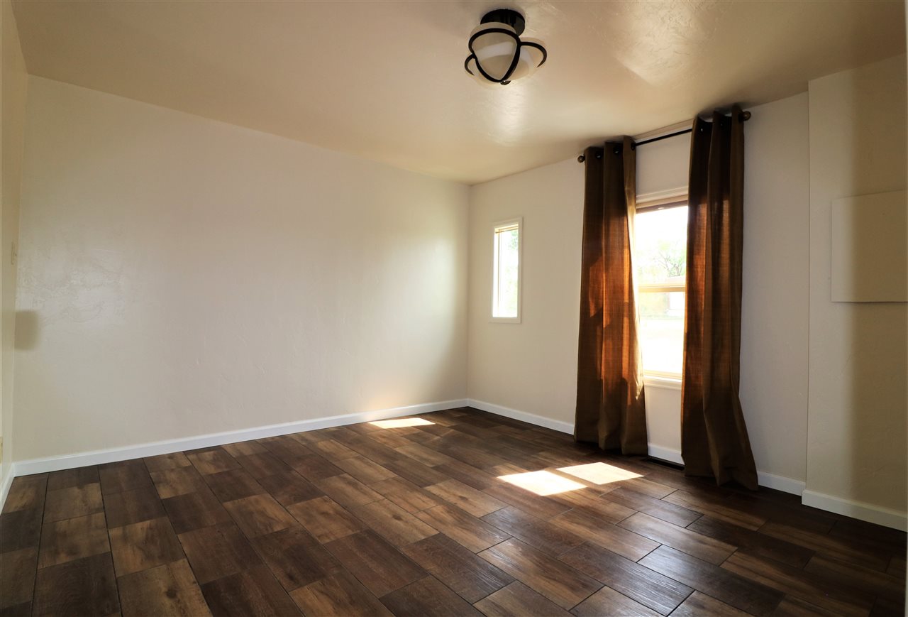 1505 10 Road Mack, CO 81525 - Photo 14 of 27 an empty room with wooden floor and windows