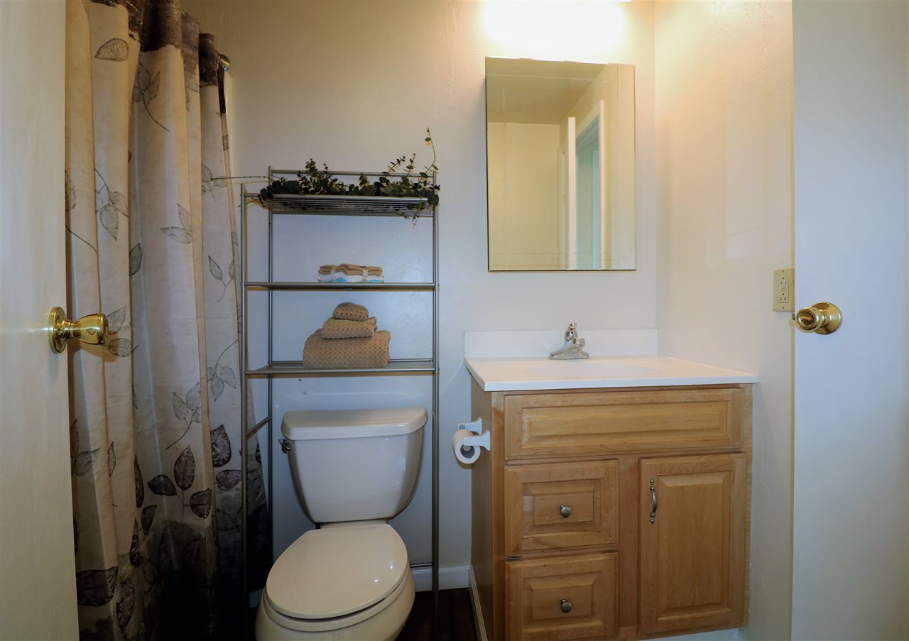 1505 10 Road Mack, CO 81525 - Photo 17 of 27 a bathroom with a toilet sink vanity and mirror