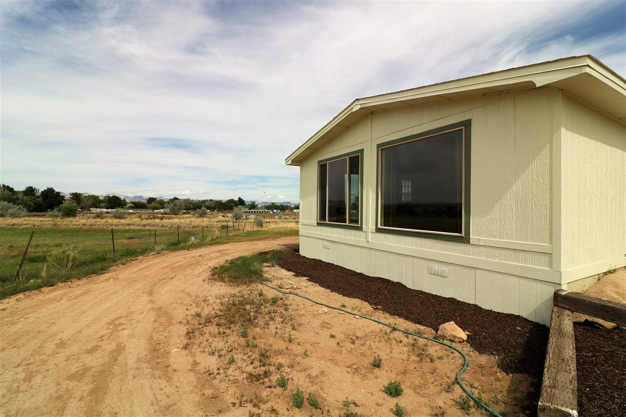 1505 10 Road Mack, CO 81525 - Photo 24 of 27 a view of a house with a yard