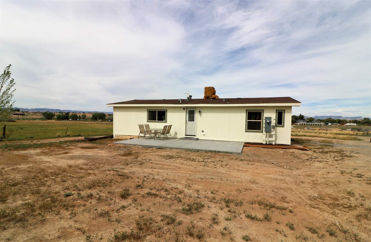 1505 10 Road Mack, CO 81525 - Photo 26 of 27 a front view of a house with a garden and pathway