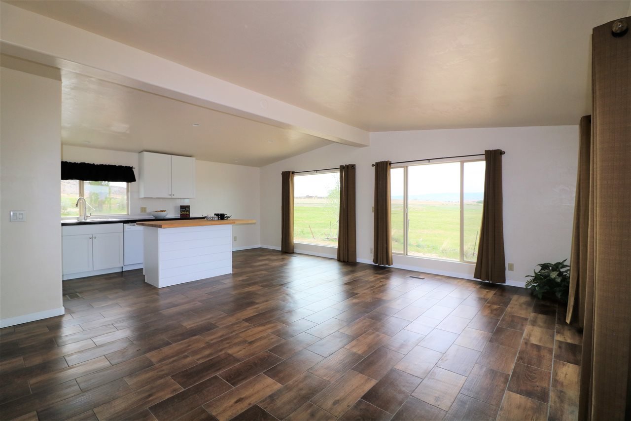 1505 10 Road Mack, CO 81525 - Photo 3 of 27 a view of an empty room with window and wooden floor