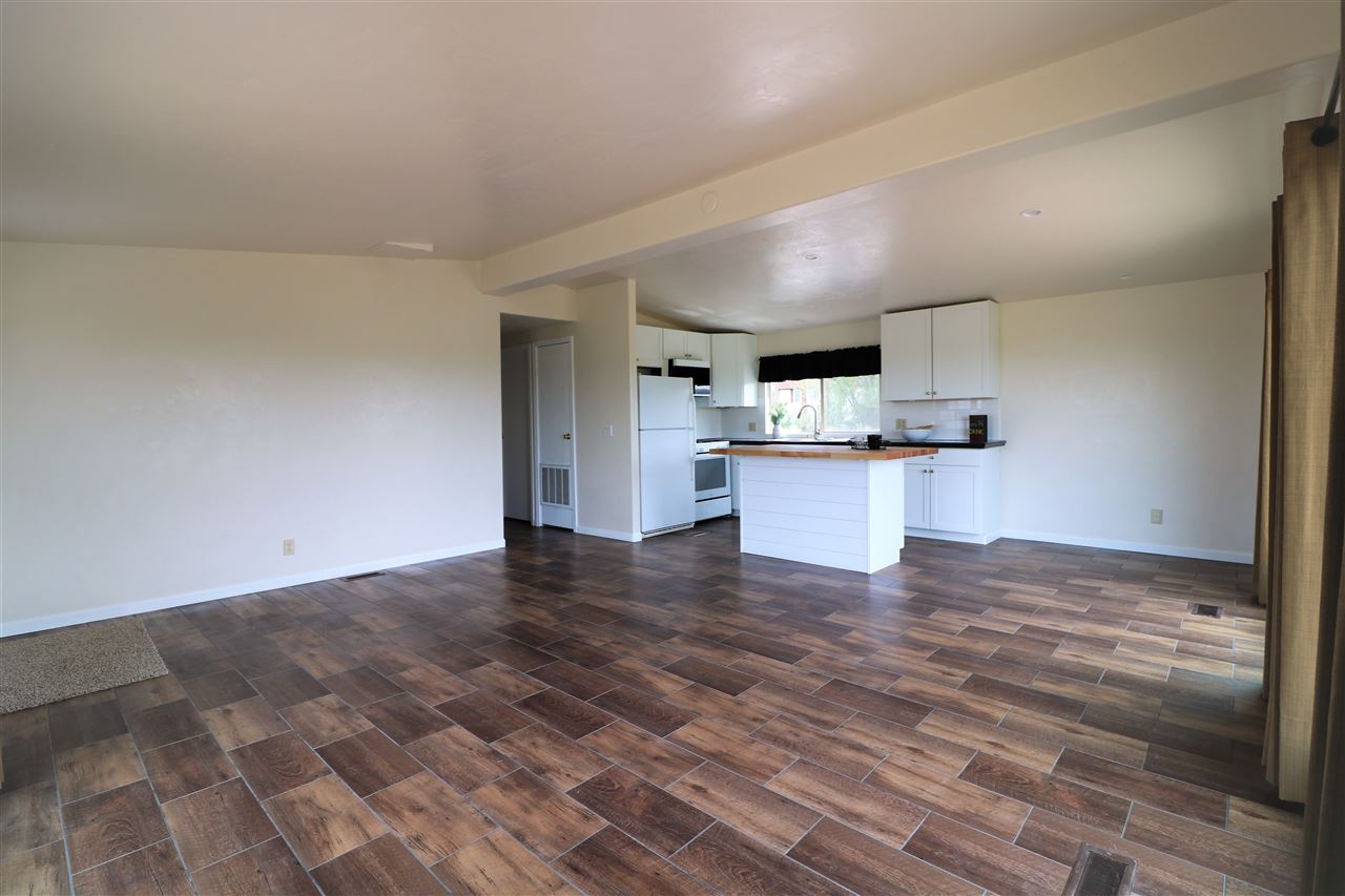 1505 10 Road Mack, CO 81525 - Photo 6 of 27 a view of a kitchen with kitchen island wooden floors and stainless steel appliances