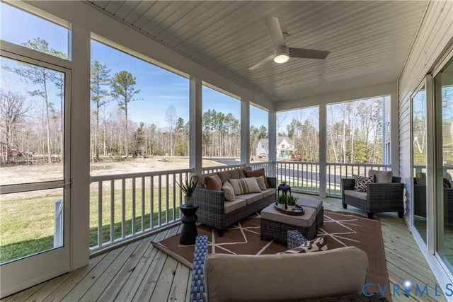 a living room with furniture and a floor to ceiling window