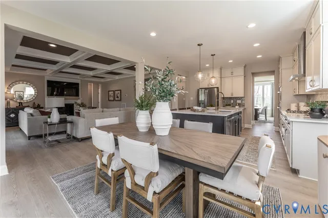 a living room with furniture fireplace and a chandelier