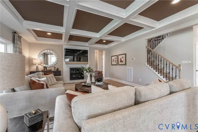 a living room with furniture fireplace and a large window