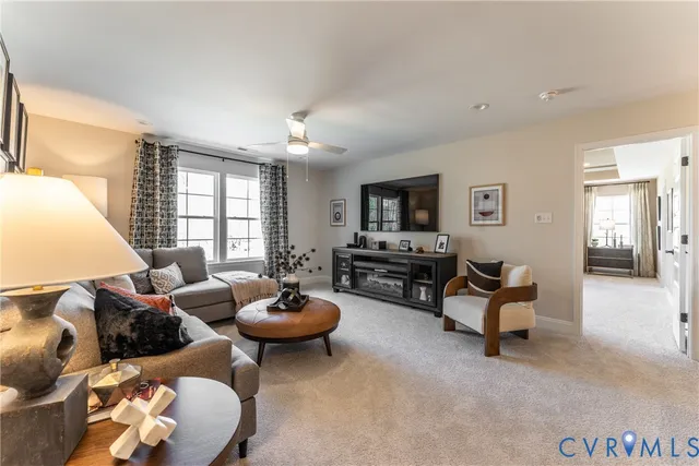 a living room with furniture and a chandelier