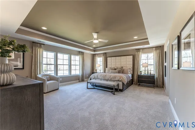 a spacious bedroom with a bed and ceiling fan