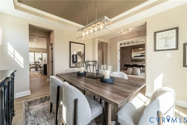 a dining room with furniture and wooden floor