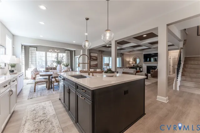 a kitchen with kitchen island a sink stove and refrigerator