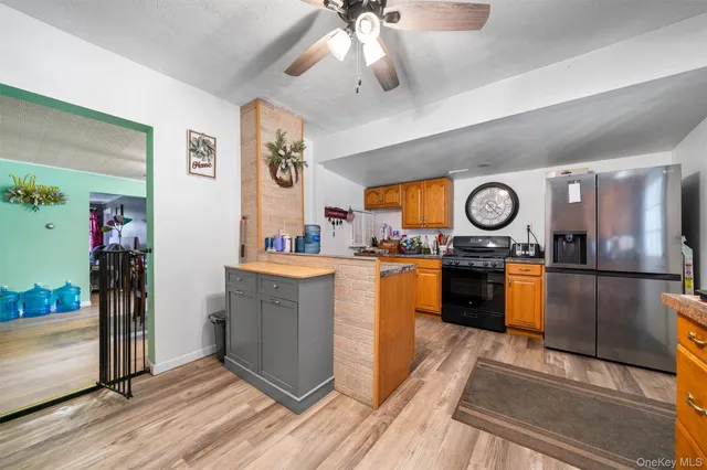 a kitchen with stainless steel appliances granite countertop a refrigerator and a stove