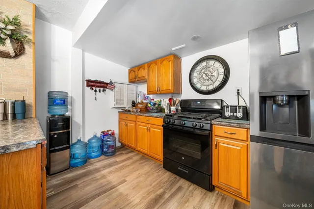 a kitchen with stainless steel appliances granite countertop a stove and a refrigerator
