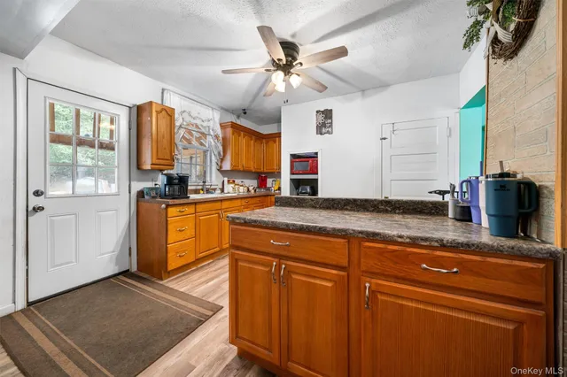 a kitchen with stainless steel appliances granite countertop a sink a stove and cabinets