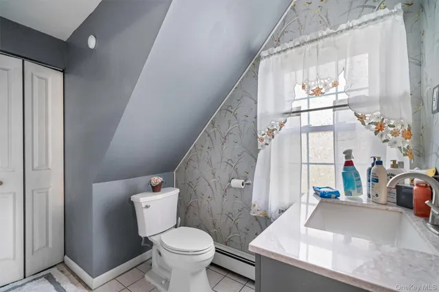 a bathroom with a granite countertop sink a toilet a mirror and shower