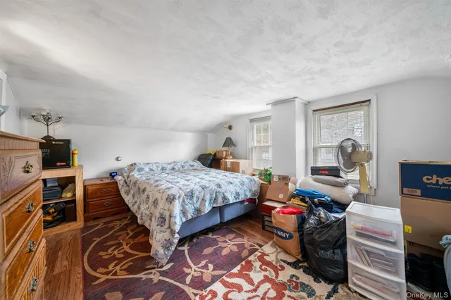 a bedroom with two beds and a large window