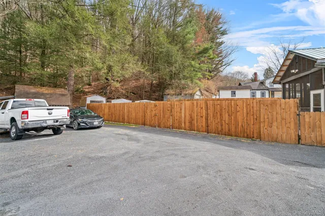 a view of a house with wooden fence