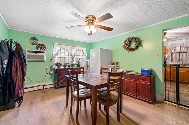 a view of a dining room with furniture and a chandelier fan