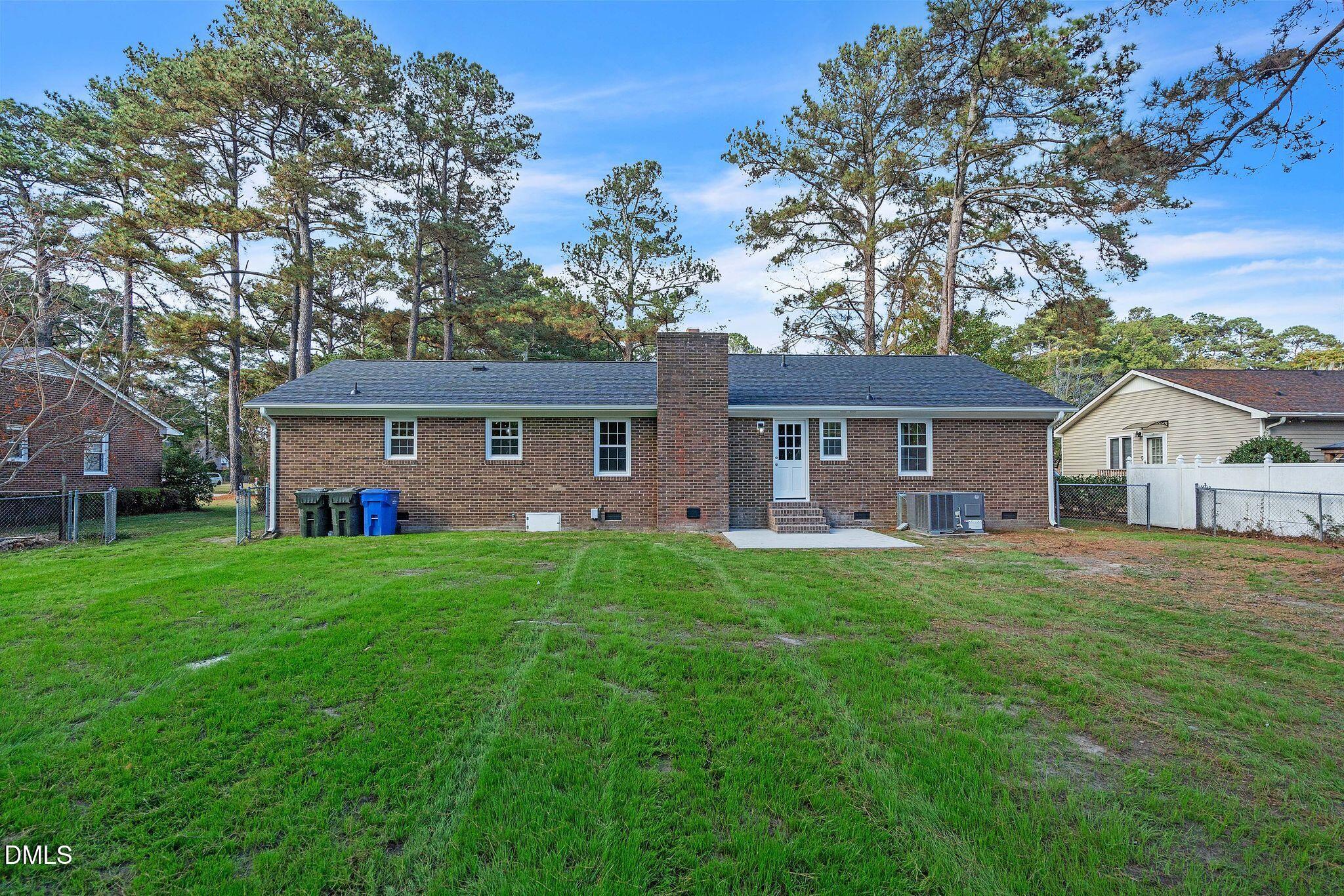 1219 Queen Anne Road Northwest Wilson, NC 27896 - Photo 26 of 26 a front view of a house with yard and green space