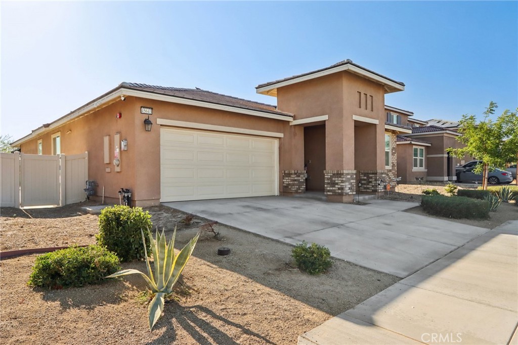 45643 Sancroft Avenue Lancaster, CA 93535 - Photo 1 of 18 a front view of a house with garden