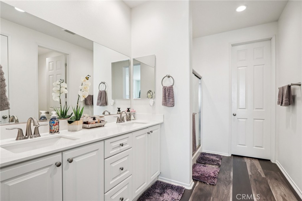 45643 Sancroft Avenue Lancaster, CA 93535 - Photo 11 of 18 a spacious bathroom with a double vanity sink and mirror