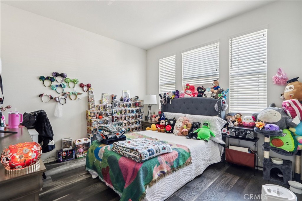 45643 Sancroft Avenue Lancaster, CA 93535 - Photo 12 of 18 a bedroom with a bed and a window