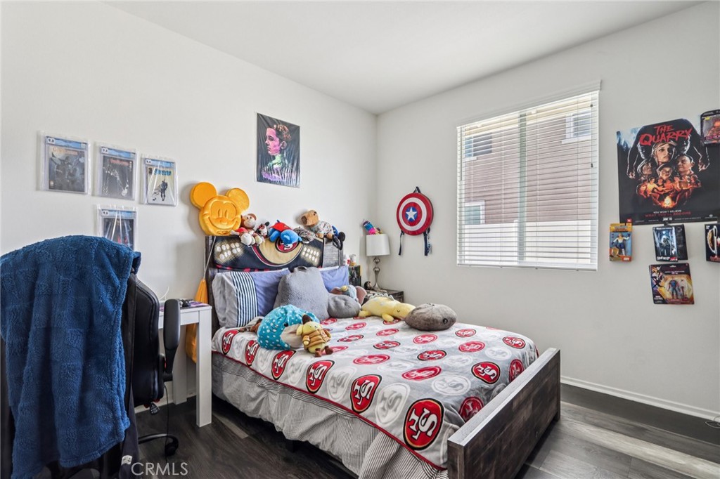 45643 Sancroft Avenue Lancaster, CA 93535 - Photo 13 of 18 a bedroom with a bed a dresser and painting on the wall