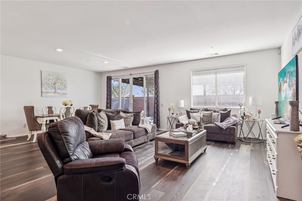 45643 Sancroft Avenue Lancaster, CA 93535 - Photo 3 of 18 a living room with furniture wooden floor and a large window