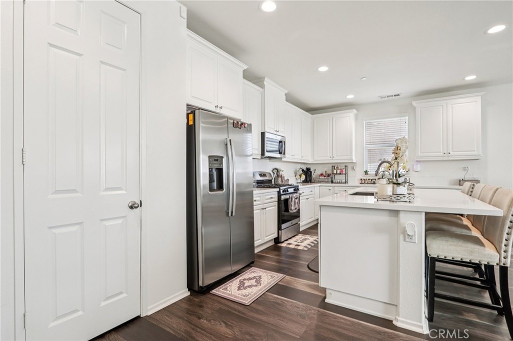 45643 Sancroft Avenue Lancaster, CA 93535 - Photo 7 of 18 a kitchen with a sink stainless steel appliances and white cabinets