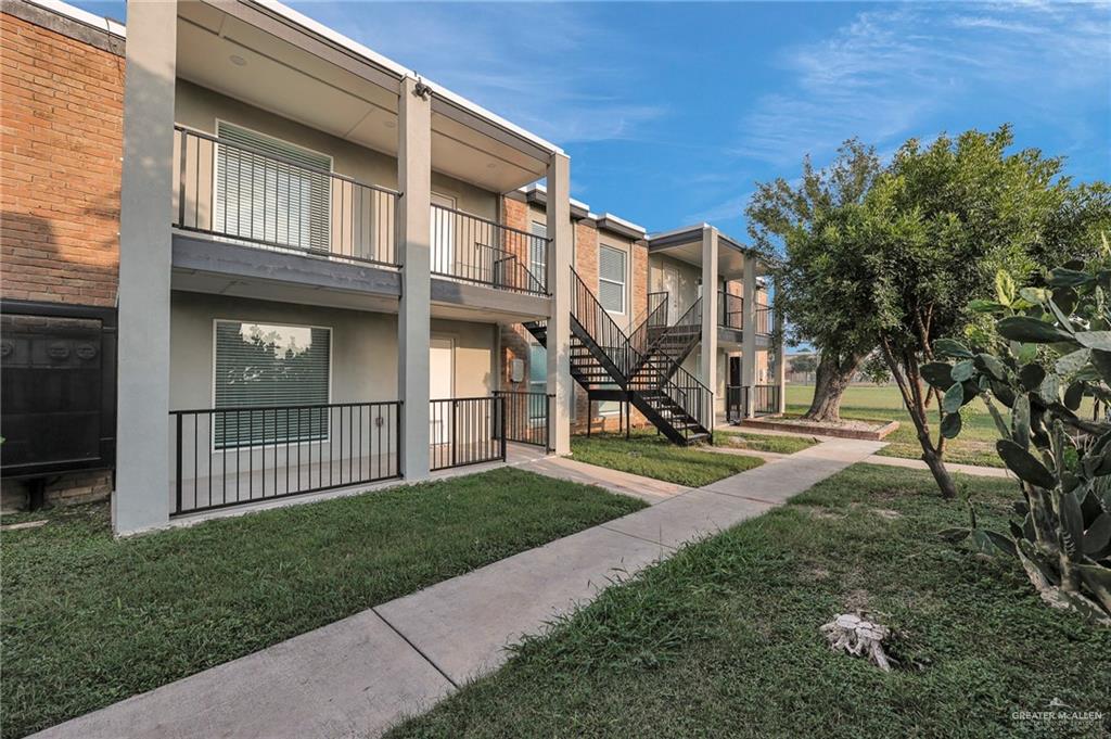 a view of a house with a yard and wooden fence
