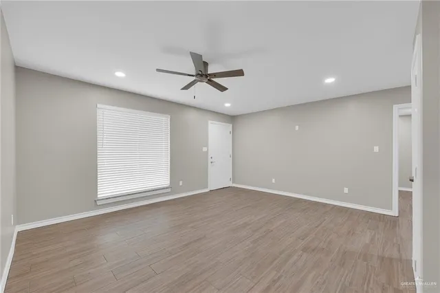 a view of kitchen with stainless steel appliances granite countertop a sink and cabinets