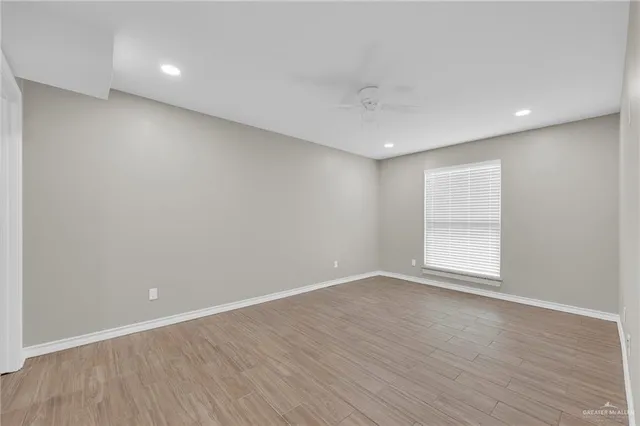 a bathroom with a granite countertop sink a toilet and a mirror