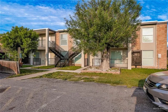 an empty room with wooden floor and a ceiling fan