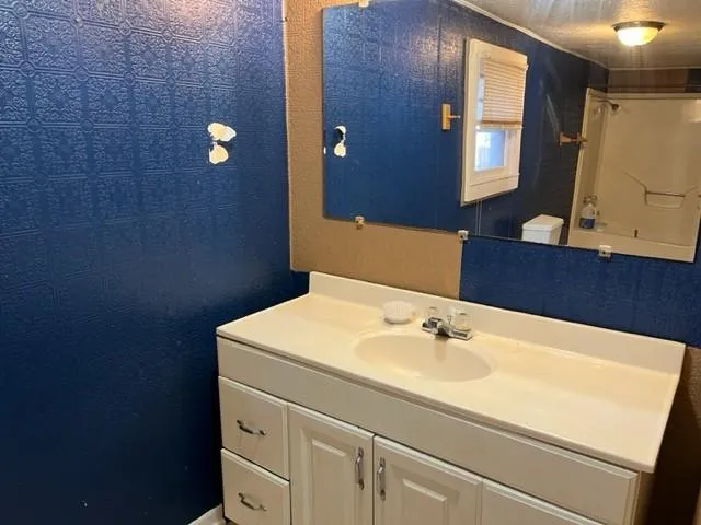 a bathroom with a sink and a mirror