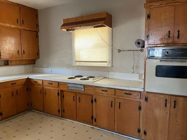 a kitchen with appliances cabinets and a sink