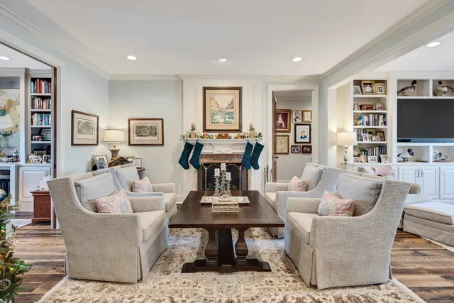 a living room with furniture kitchen view and a flat screen tv