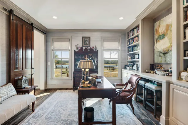 a living room with furniture and a floor to ceiling window